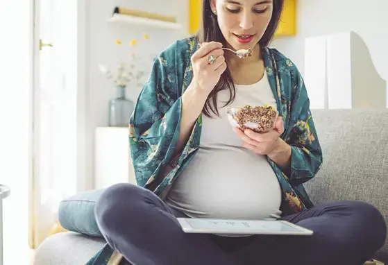 Mujer embarazada comiendo smothie