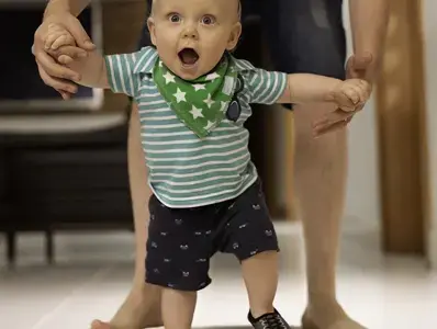 Papa ayudando a su hijo a caminar